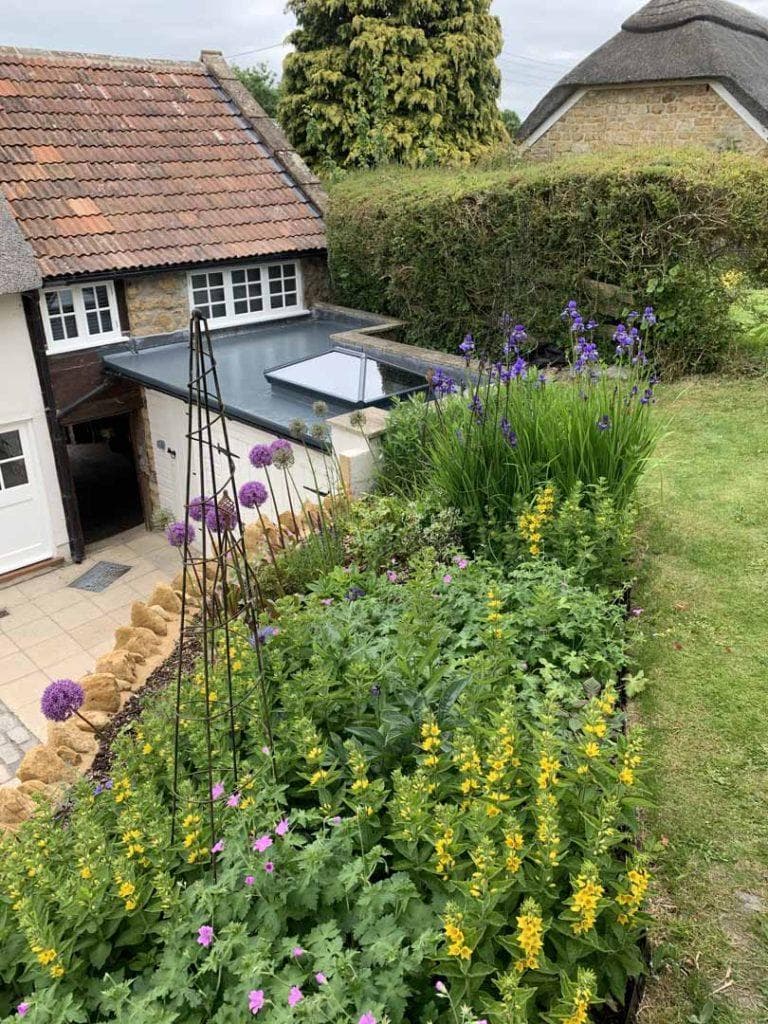 Flat roof installation with skylight by JJS Roofing
